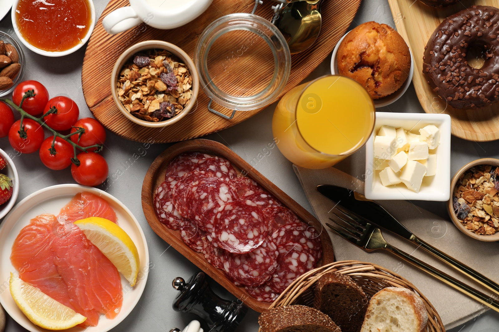 Photo of Different tasty food served for brunch on grey table, flat lay