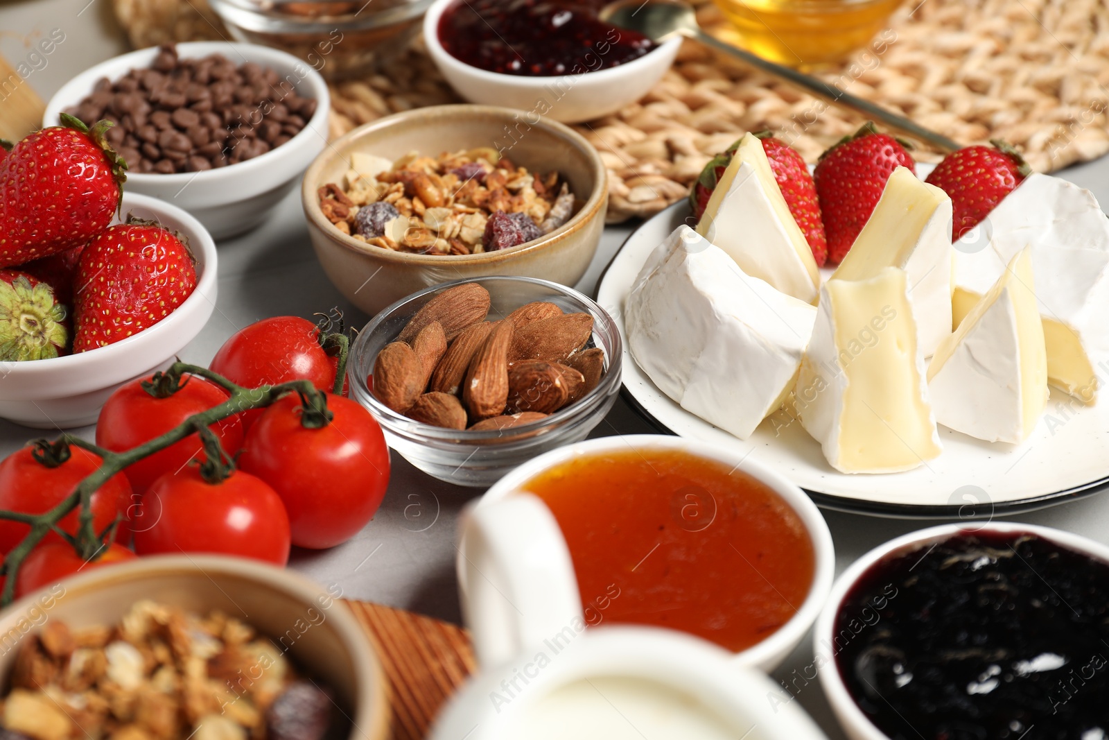 Photo of Different tasty food served for brunch on grey table