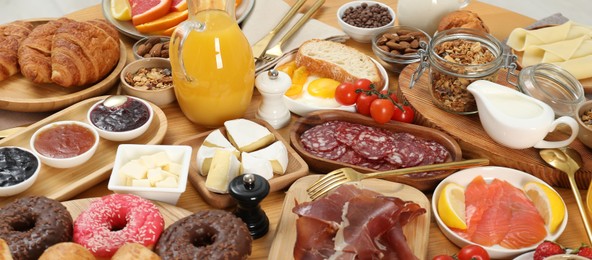 Photo of Different tasty food served for brunch on wooden table