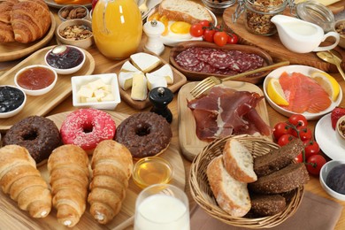 Photo of Different tasty food served for brunch on wooden table