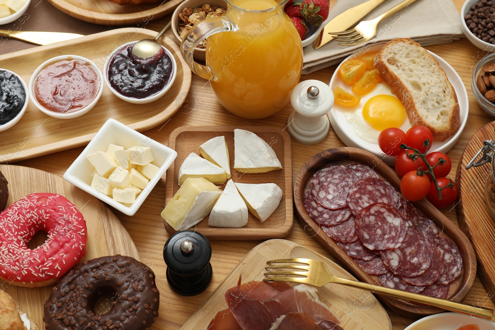 Photo of Different tasty food served for brunch on wooden table, flat lay