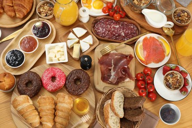 Photo of Different tasty food served for brunch on wooden table, flat lay