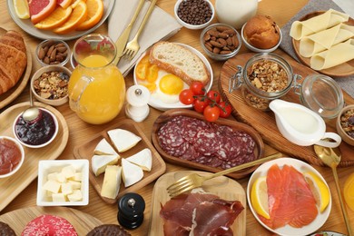 Photo of Different tasty food served for brunch on wooden table, flat lay