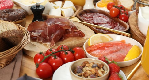 Photo of Different tasty food served for brunch on wooden table