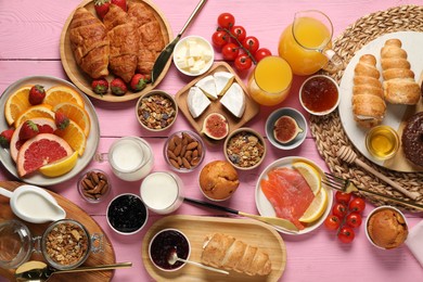 Photo of Different tasty food served for brunch on pink wooden table, flat lay