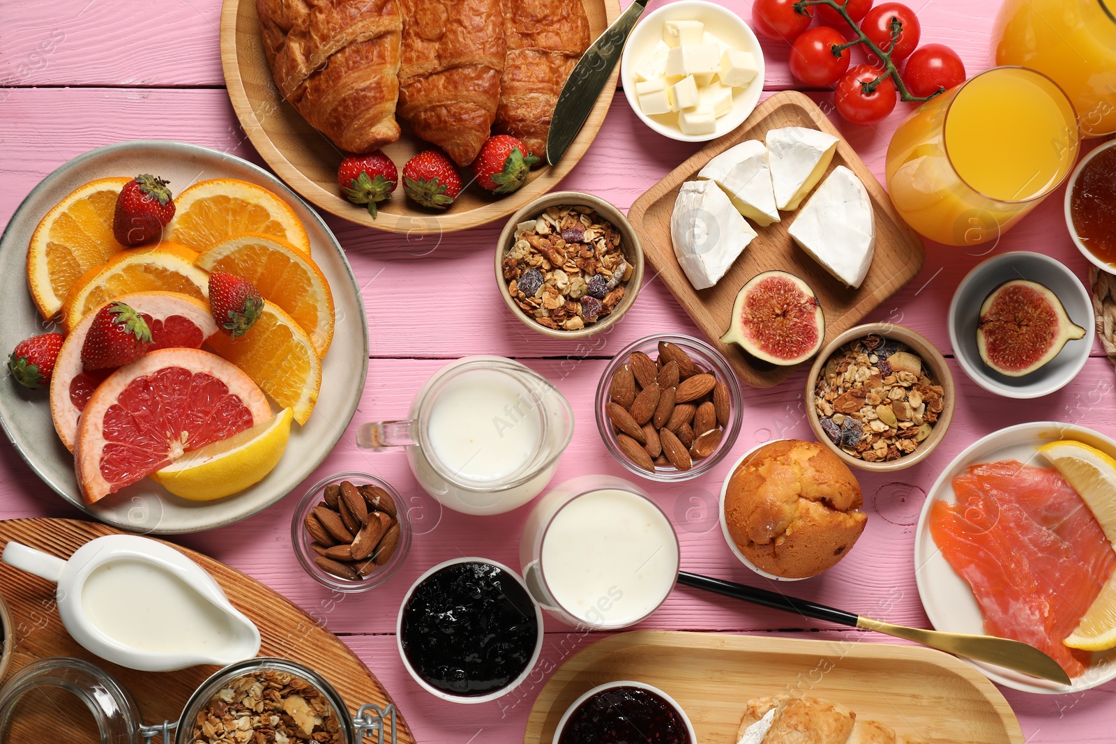 Photo of Different tasty food served for brunch on pink wooden table, flat lay