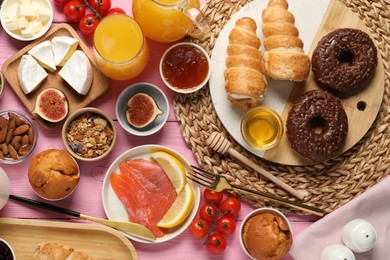 Photo of Different tasty food served for brunch on pink wooden table, flat lay