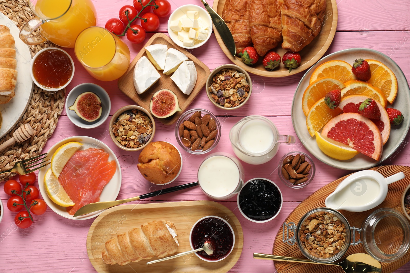 Photo of Different tasty food served for brunch on pink wooden table, flat lay