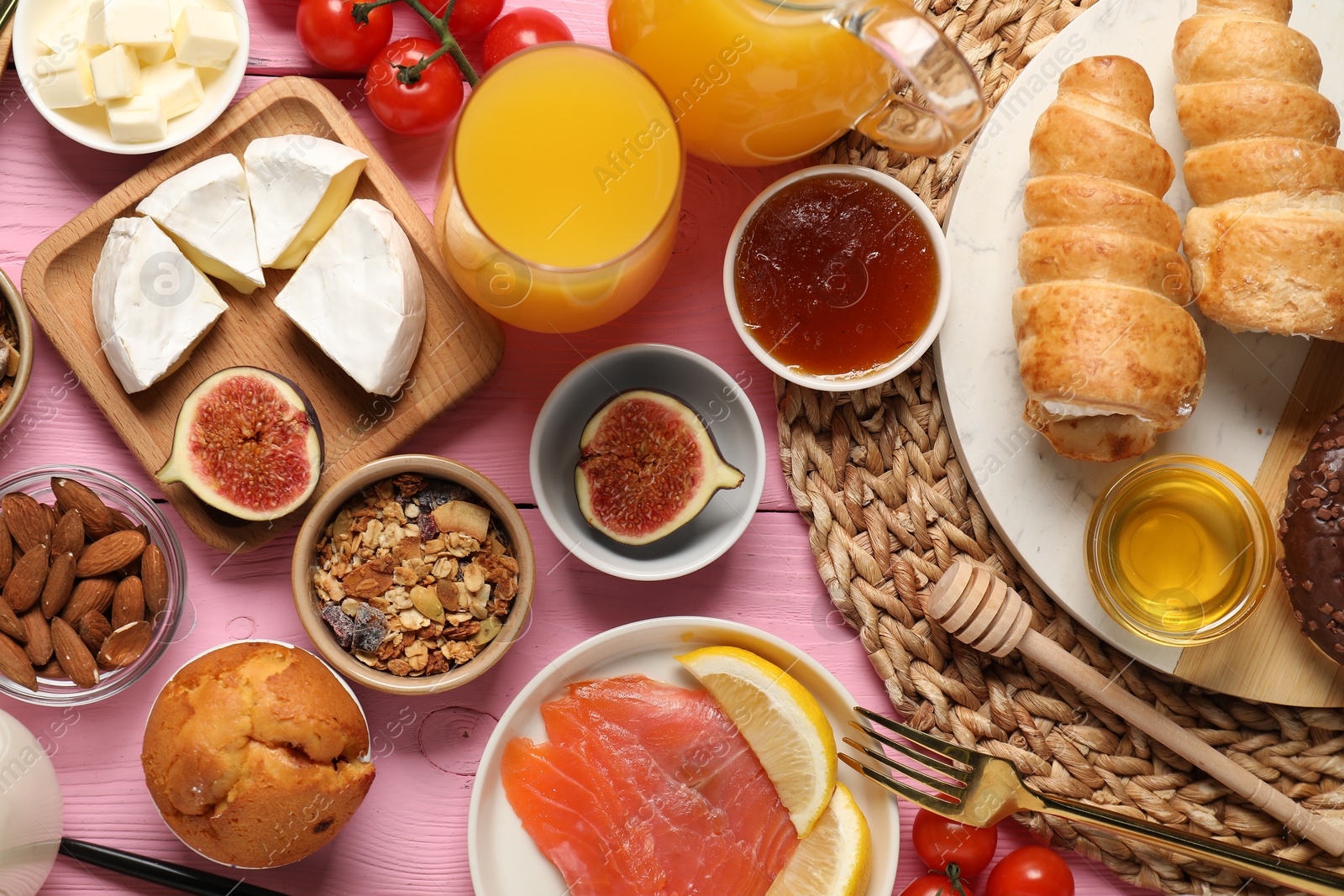 Photo of Different tasty food served for brunch on pink wooden table, flat lay