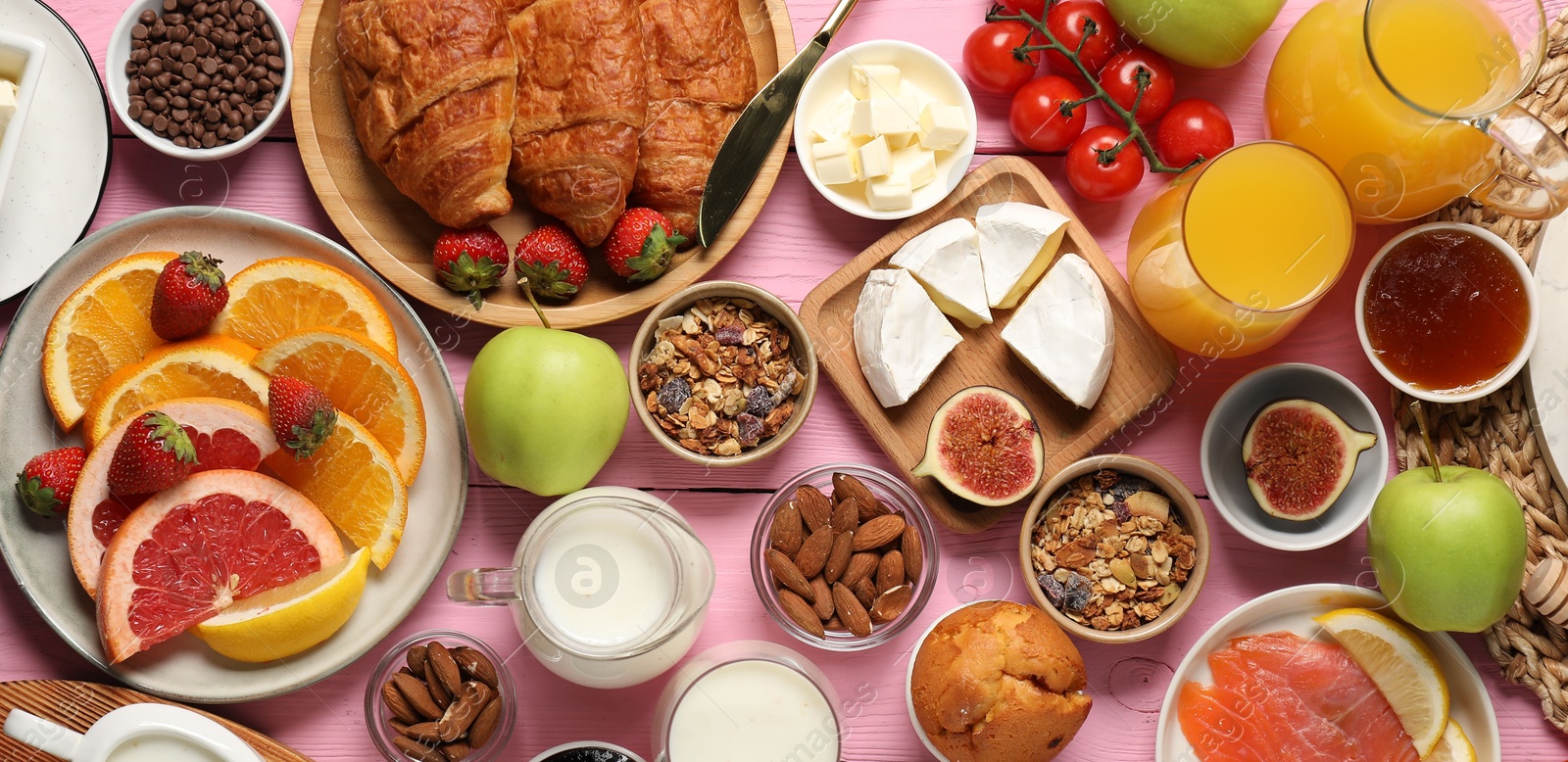 Photo of Different tasty food served for brunch on pink wooden table, flat lay