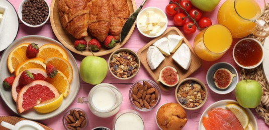 Photo of Different tasty food served for brunch on pink wooden table, flat lay