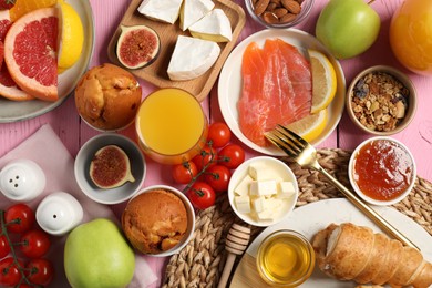 Photo of Different tasty food served for brunch on pink wooden table, flat lay