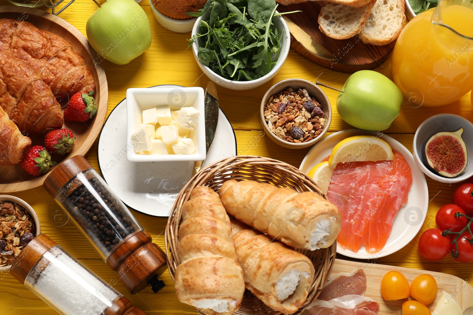 Photo of Different tasty food served for brunch on yellow wooden table, flat lay