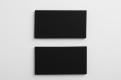 Photo of Blank business cards on light grey background, top view. Mockup for design