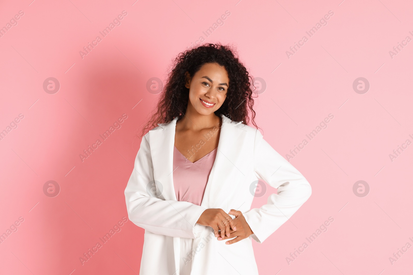 Photo of Beautiful woman in stylish jacket on pink background