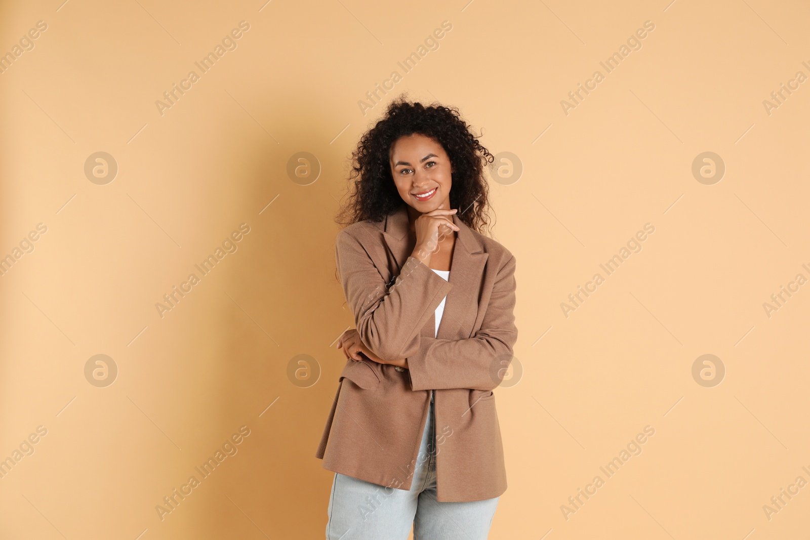 Photo of Beautiful woman in stylish jacket on beige background