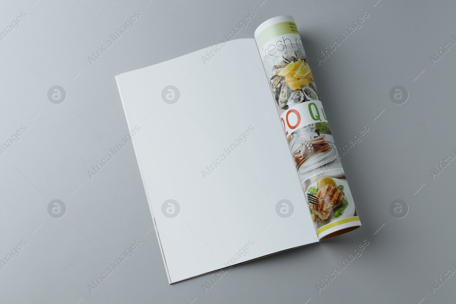 Photo of Open magazine on grey background, top view. Mockup for design