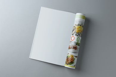 Photo of Open magazine on grey background, top view. Mockup for design