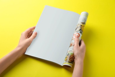 Photo of Woman reading magazine on yellow background, closeup. Mockup for design