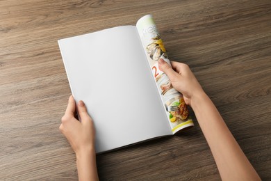 Woman reading magazine at wooden table, closeup. Mockup for design