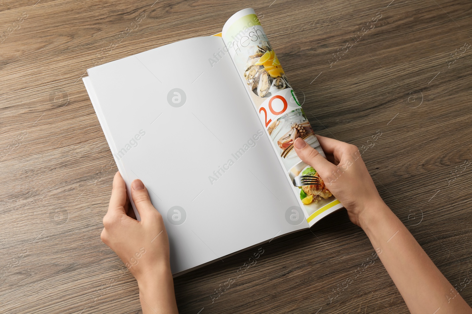 Photo of Woman reading magazine at wooden table, closeup. Mockup for design