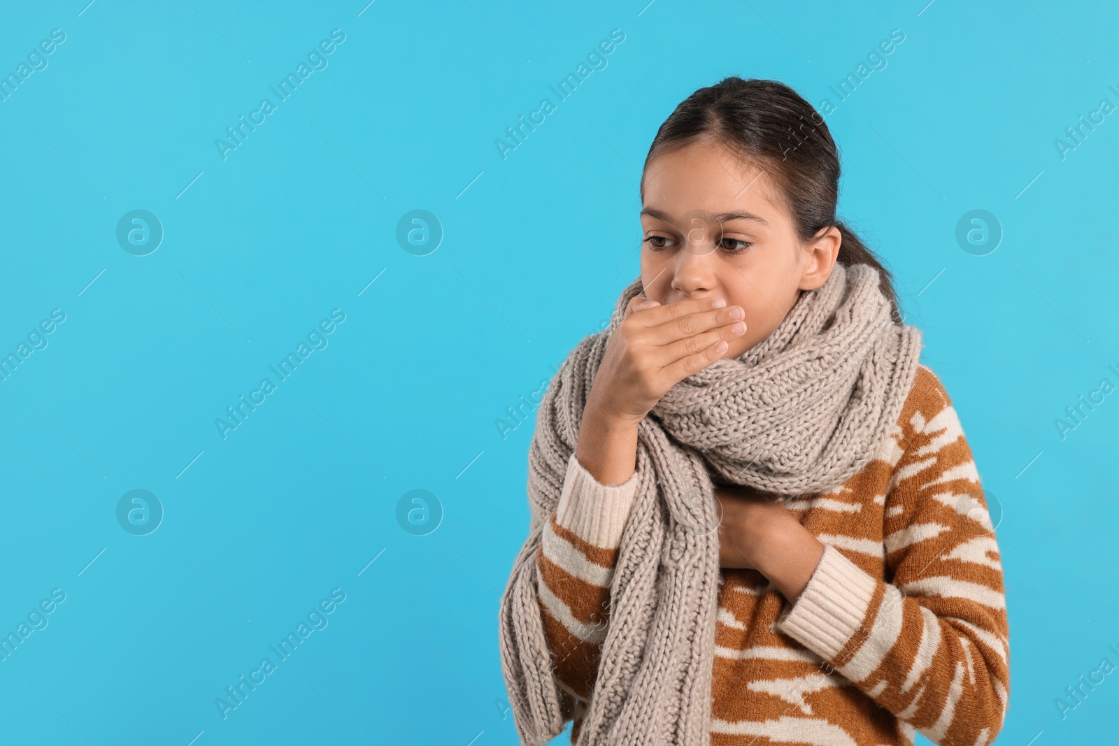 Photo of Cold symptom. Little girl suffering from fever on light blue background, space for text