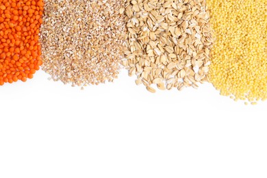 Photo of Piles of different cereals and lentils isolated on white, top view