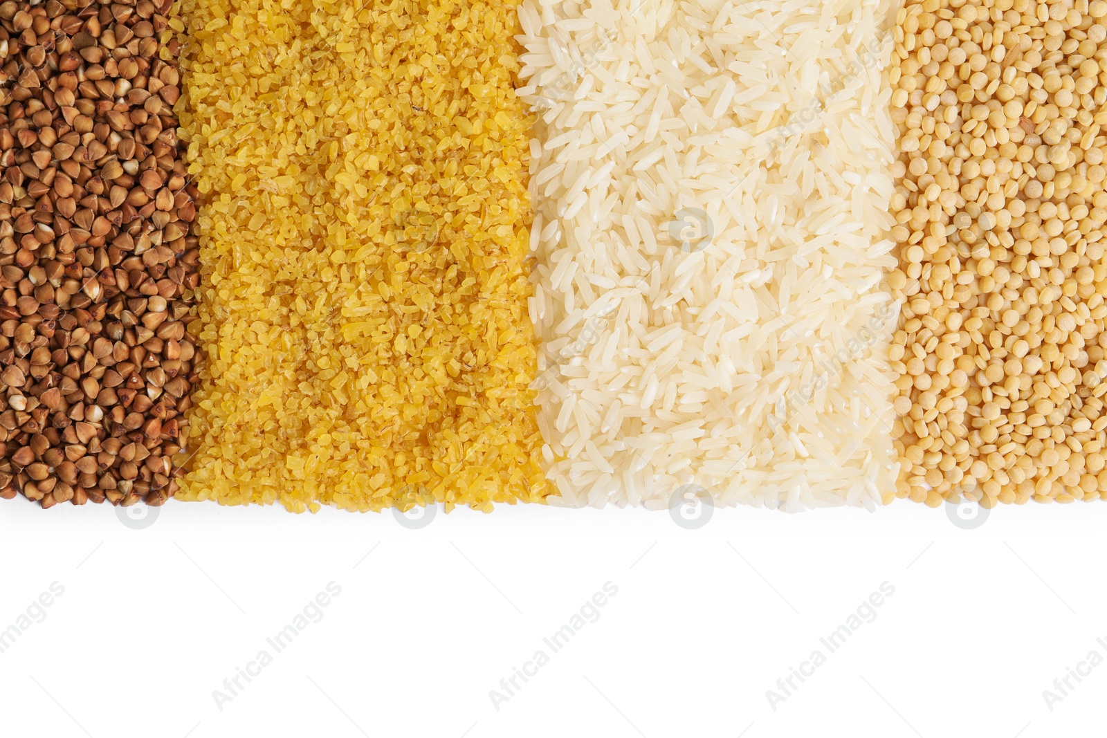 Photo of Piles of different cereals isolated on white, top view