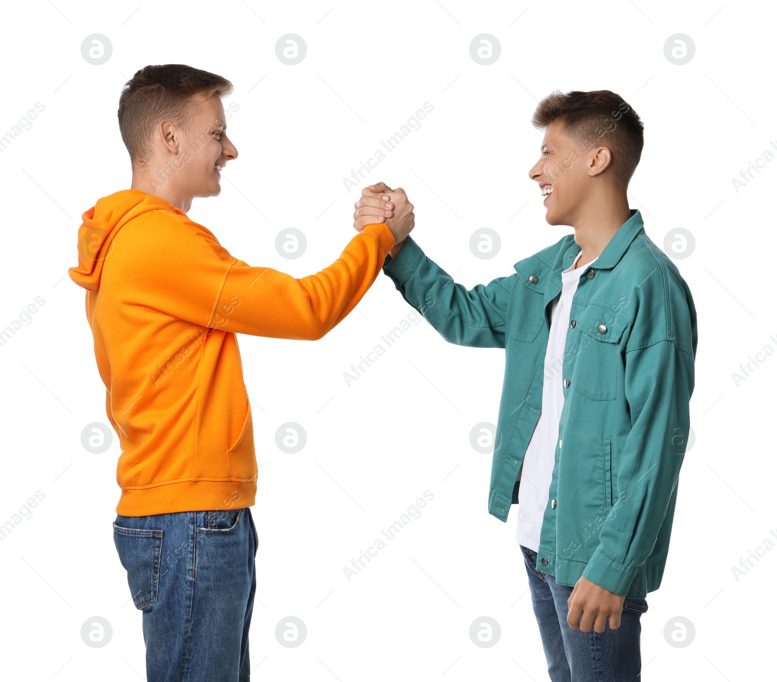 Photo of Two young brothers clasping hands on white background