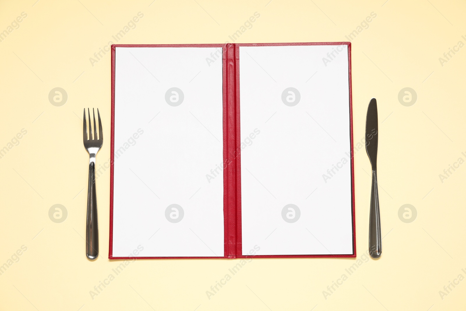 Photo of Hardcover notebook with blank sheets for menu design and cutlery on beige table, flat lay