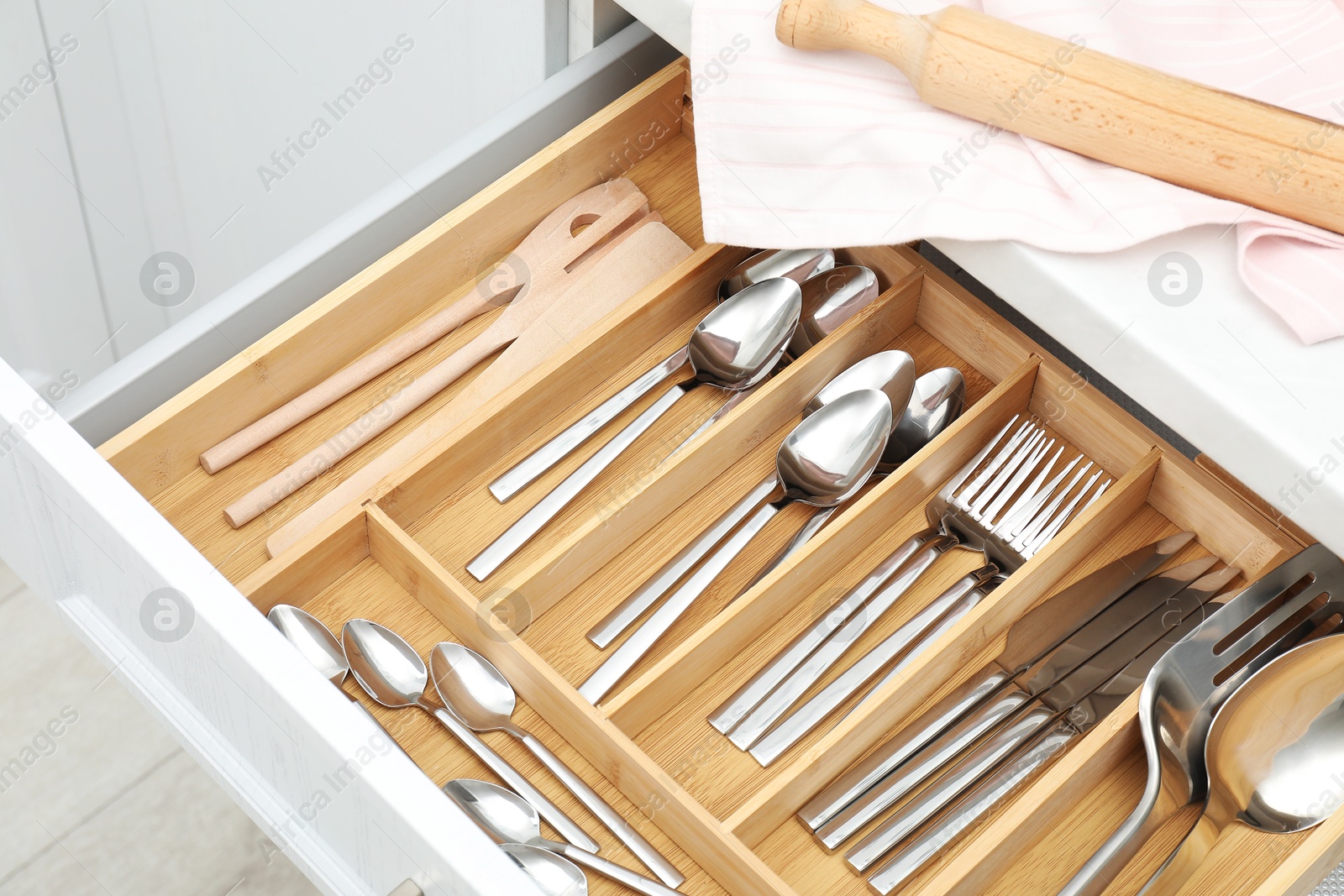 Photo of Box with cutlery in drawer, closeup. Kitchen utensils storage