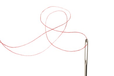 Sewing needle with red thread isolated on white