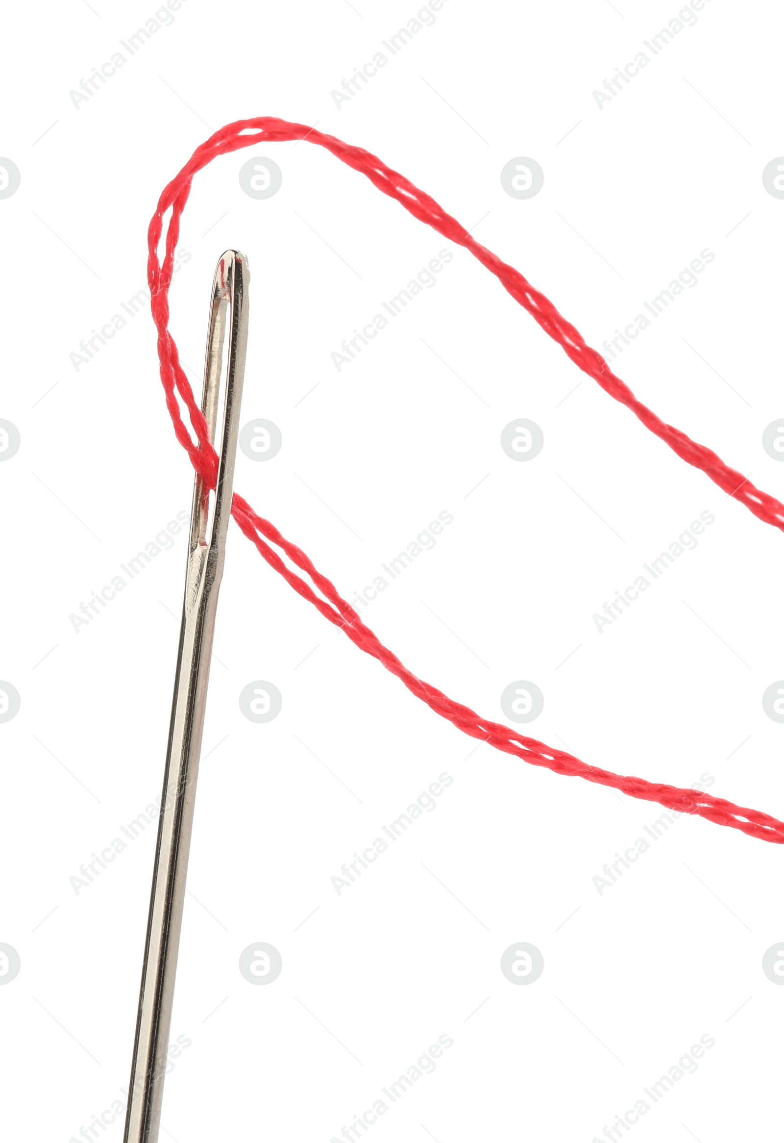 Photo of Sewing needle with red thread isolated on white