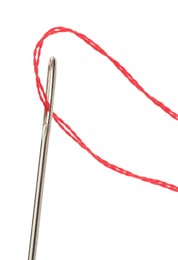 Photo of Sewing needle with red thread isolated on white