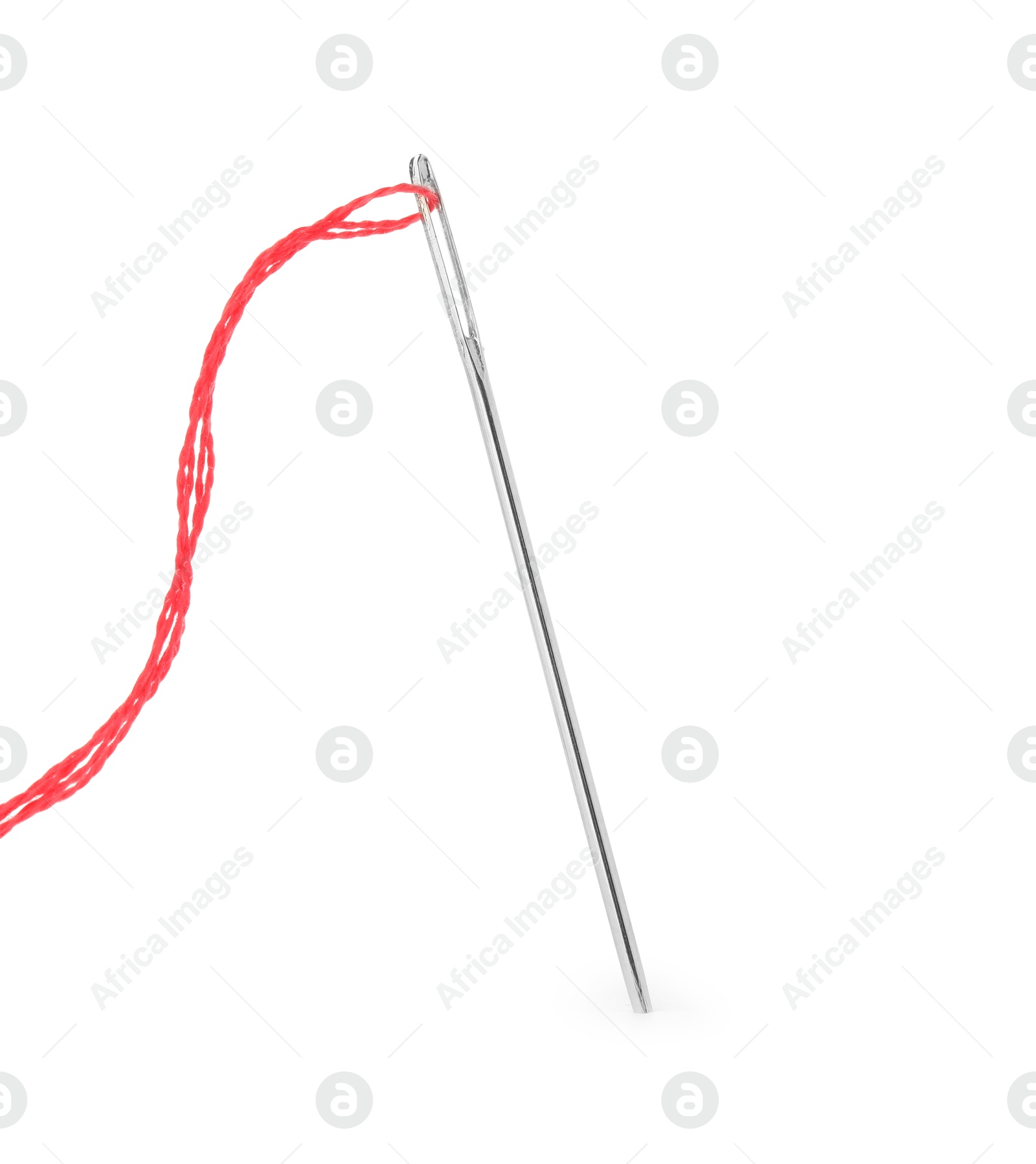 Photo of Sewing needle with red thread isolated on white