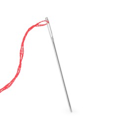 Photo of Sewing needle with red thread isolated on white