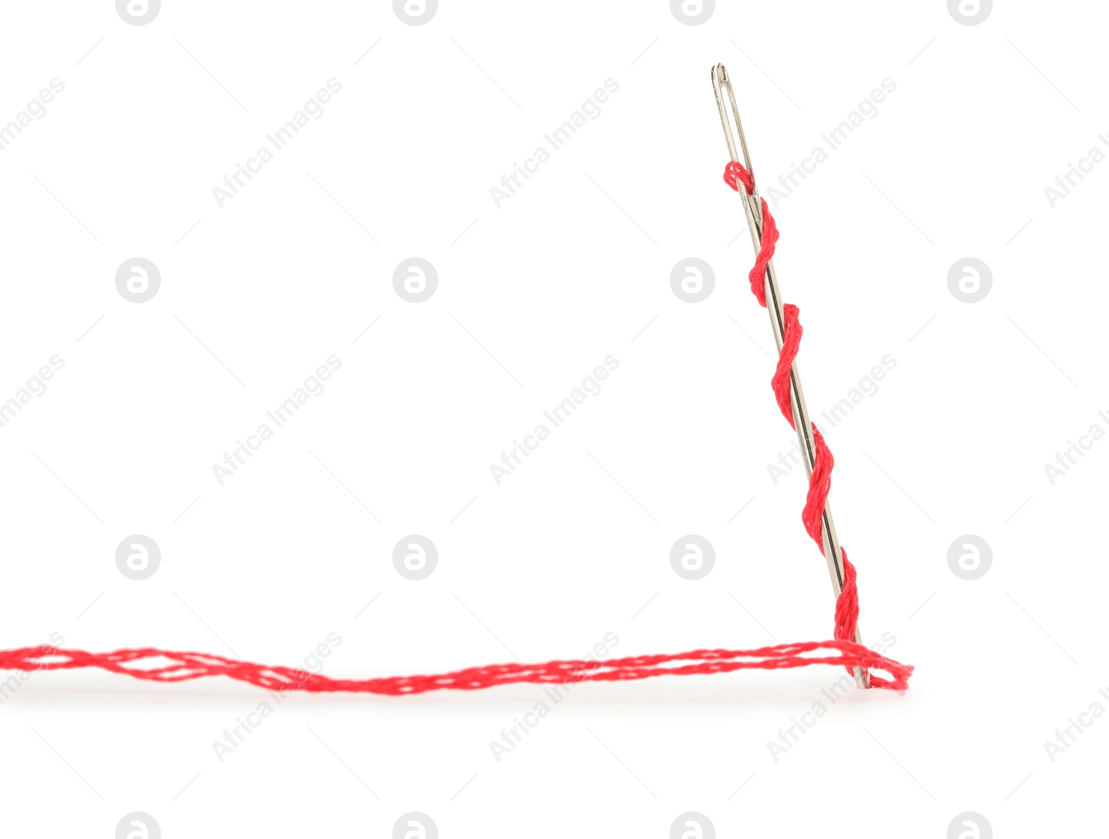 Photo of Sewing needle with red thread isolated on white