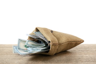 Photo of Dollar banknotes in bag on wooden table against white background