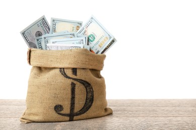 Photo of Dollar banknotes in bag on wooden table against white background, space for text