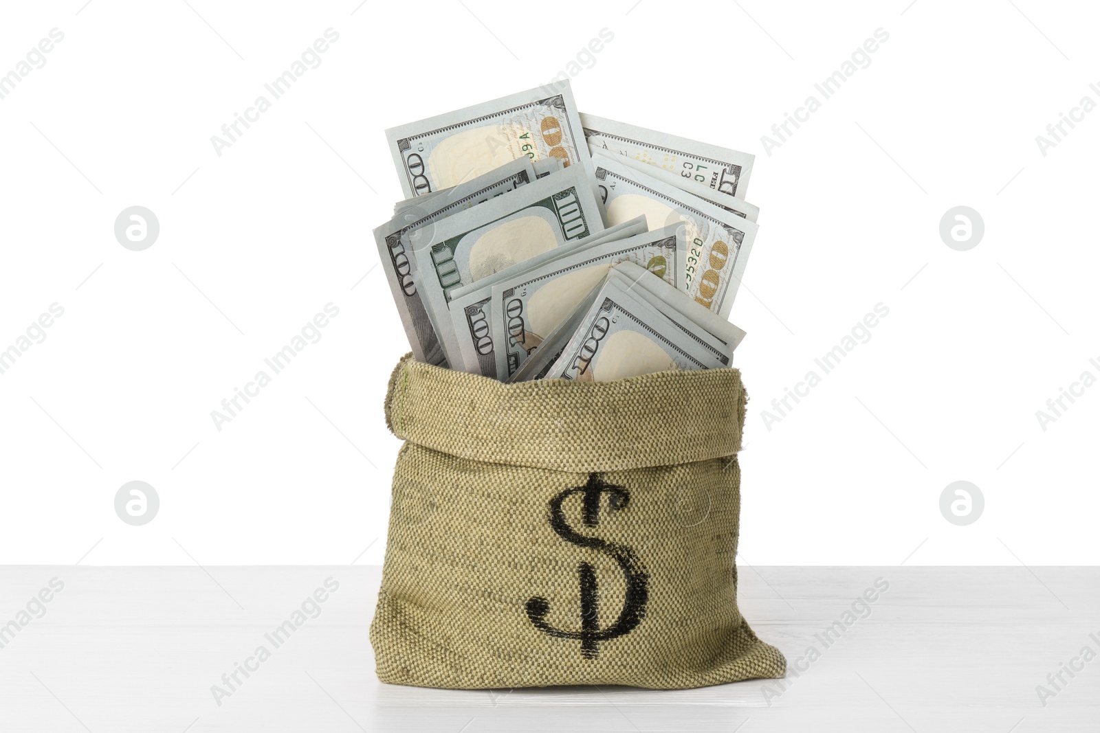 Photo of Dollar banknotes in bag on table against white background