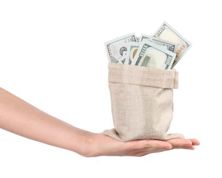 Photo of Woman with bag of dollar banknotes against light background, closeup