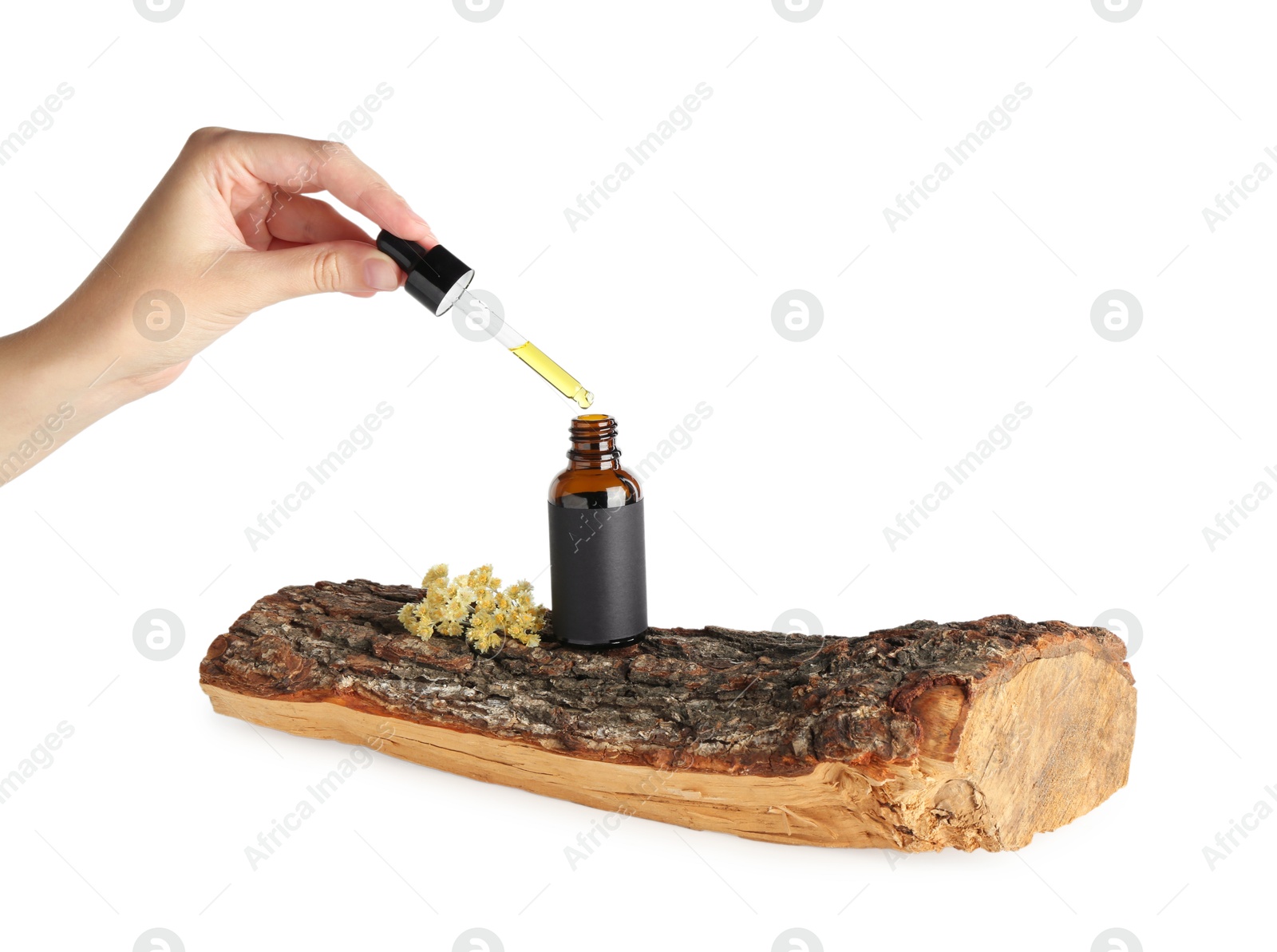 Photo of Woman dripping tincture from pipette into bottle against white background, closeup