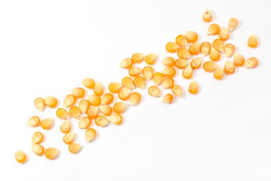 Many fresh corn kernels on white background, flat lay