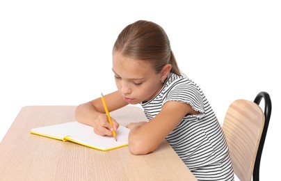 Girl with incorrect posture and notebook sitting at wooden desk on white background