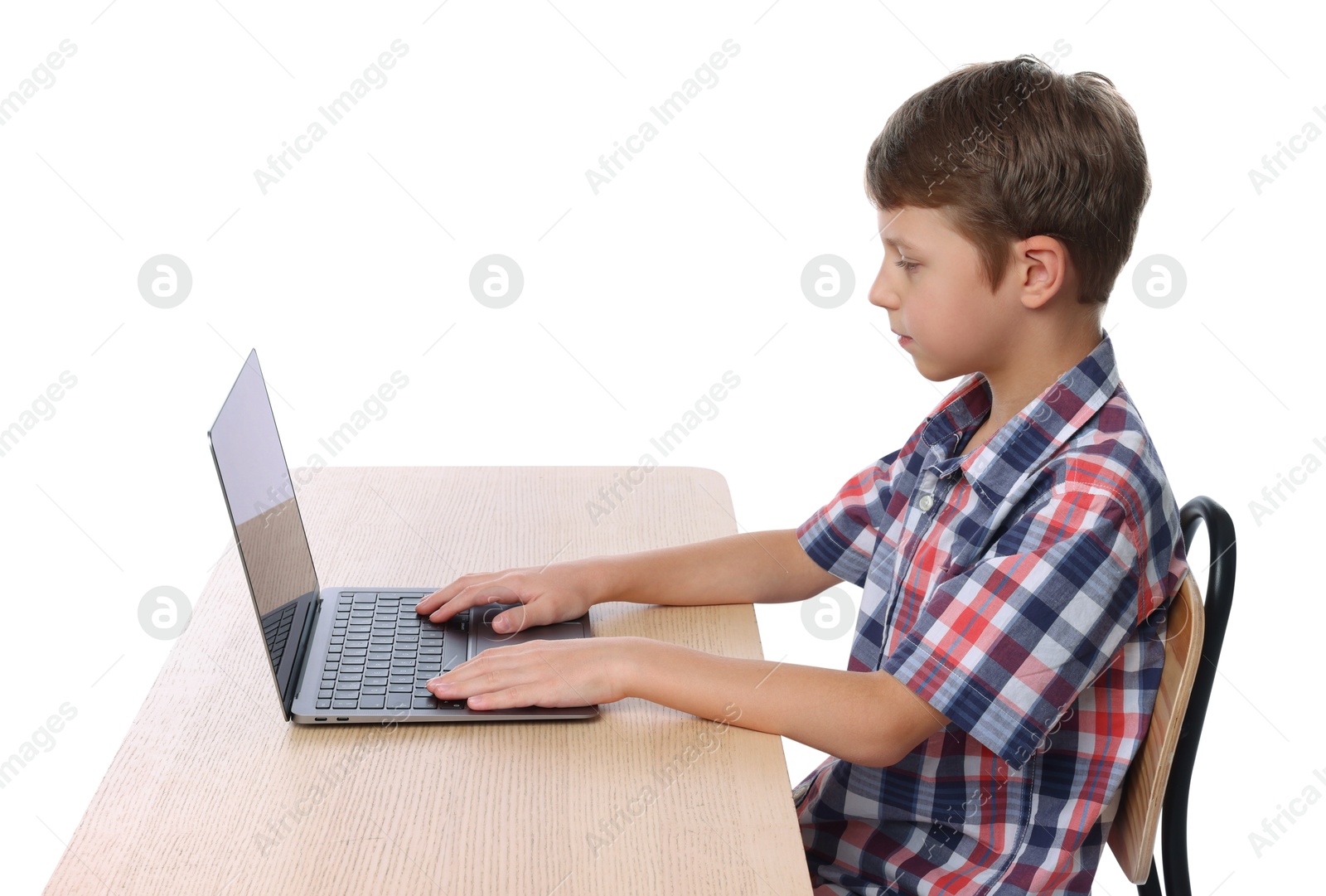 Photo of Boy with correct posture using laptop at wooden desk on white background