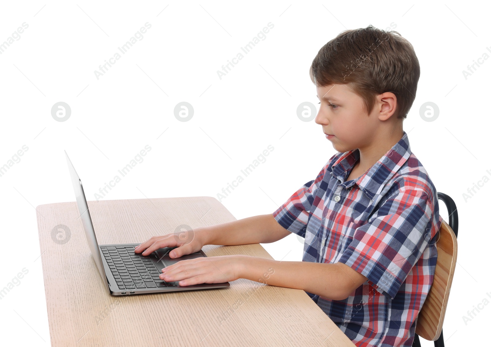 Photo of Boy with correct posture using laptop at wooden desk on white background