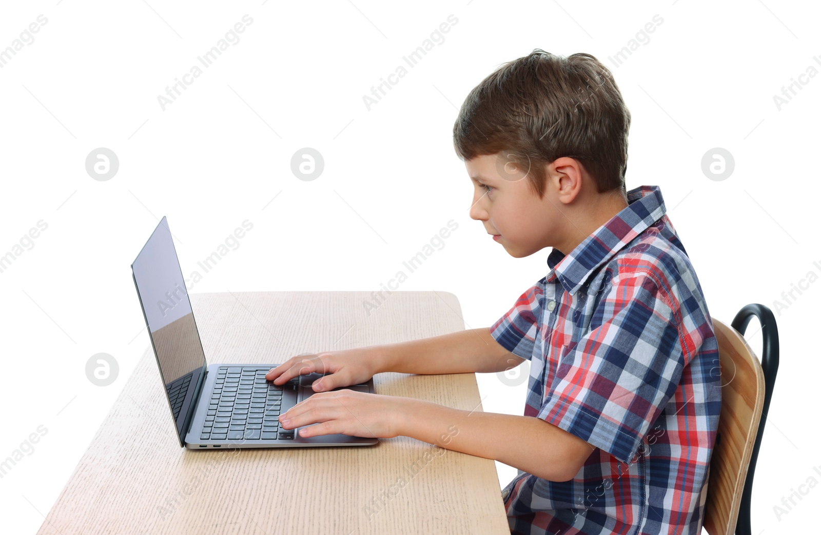 Photo of Boy with incorrect posture using laptop at wooden desk on white background