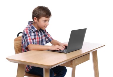 Photo of Boy with incorrect posture using laptop at wooden desk on white background