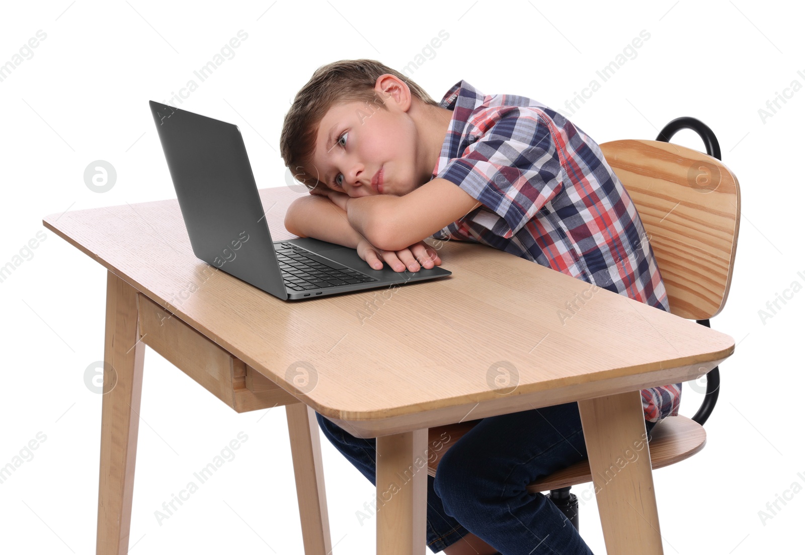 Photo of Boy with incorrect posture using laptop at wooden desk on white background