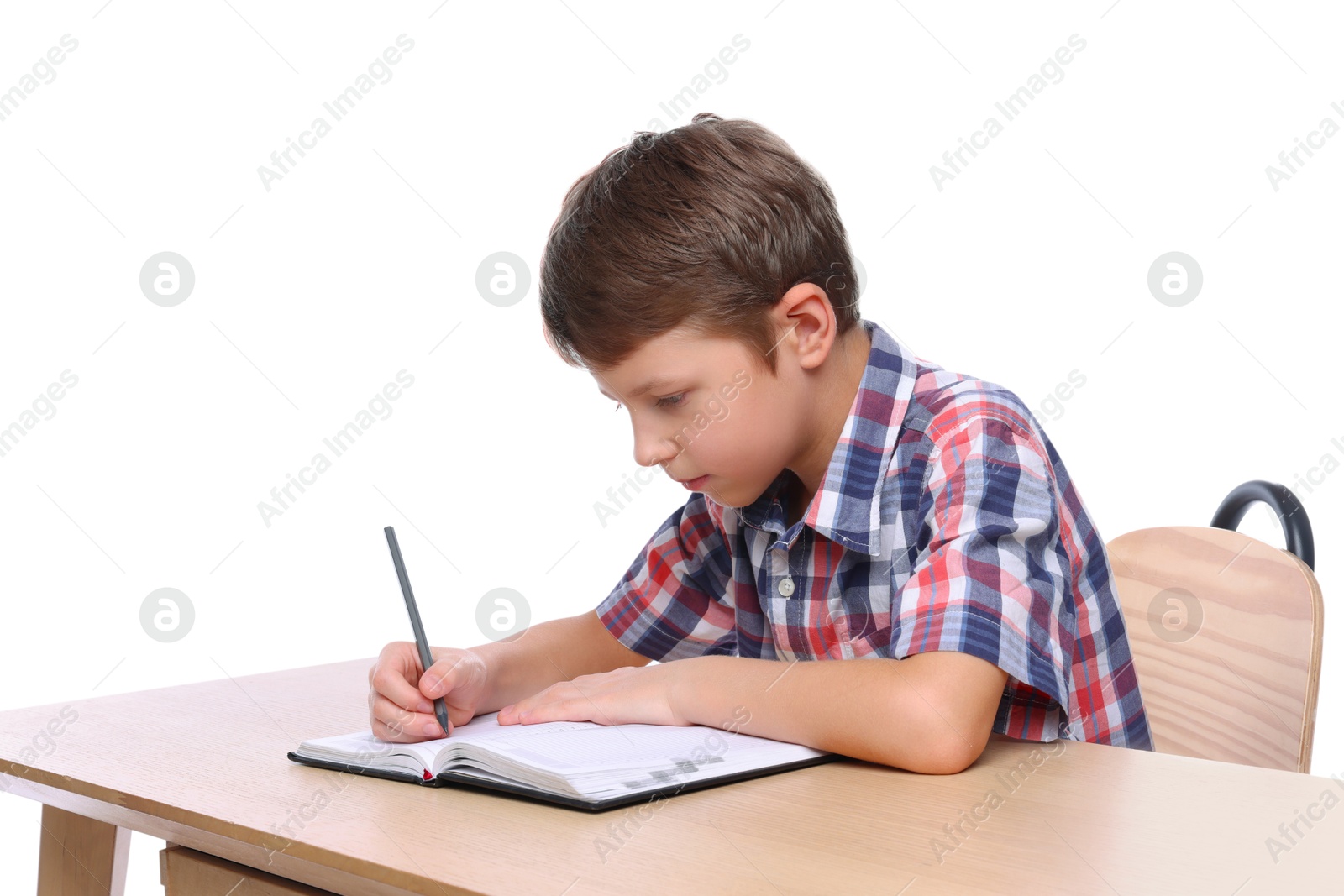 Photo of Boy with incorrect posture and notebook at wooden desk on white background